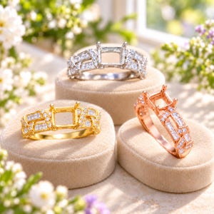 May include: Three ring settings in silver, yellow gold, and rose gold tones. Each ring features a central four-prong mount for a square stone, surrounded by a woven band design encrusted with small baguette and round cut clear stones.