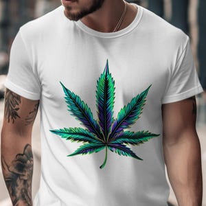 May include: White t-shirt featuring a large, detailed cannabis leaf design. The leaf is rendered in shades of green, blue, and purple, creating a vibrant and eye-catching graphic. The shirt is a classic crew neck style.