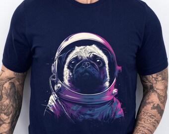 May include: Navy blue t-shirt featuring a pug wearing an astronaut helmet. The pug's face is detailed with a serious expression, and the helmet is rendered in shades of purple and blue. The design is centered on the shirt, creating a unique and eye-catching graphic.