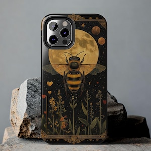 May include: A black phone case with a bee and moon design. The bee is gold and black and is flying in front of a full moon. The background is a dark blue with stars and flowers.