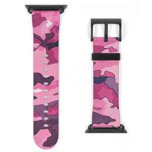 May include: Two watch straps with a pink camouflage pattern. The straps have a black clasp and connectors. The camouflage design features shades of pink, purple, and white. The straps are shown against a white background.