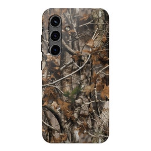 May include: A camouflage phone case with a brown, green, and white pattern. The case has a raised camera bump with three black camera lenses.