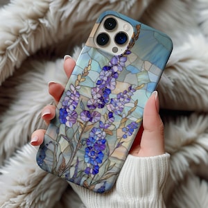 May include: A phone case with a stained glass design featuring purple and blue flowers on a light blue background.