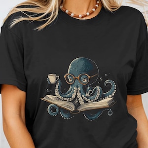 May include: Black t-shirt with a graphic of an octopus wearing glasses and holding a cup of coffee, reading a book.