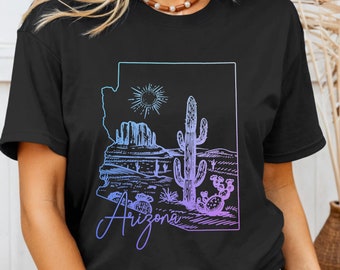 May include: Black t-shirt with a graphic of the state of Arizona, featuring a desert landscape with cacti and the text "Arizona" in a purple gradient.