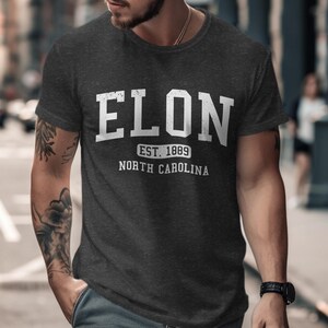 Dark gray t-shirt with "ELON EST. 1889 NORTH CAROLINA" in white text.