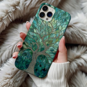 May include: A white ceramic mug with a black handle and the text "But First, Coffee" in a black, handwritten-style font. The mug is on a white surface.