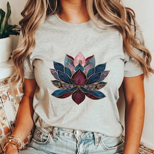 May include: A gray t-shirt with a colorful lotus flower design. The flower is made up of blue, purple, pink, and gold hues.