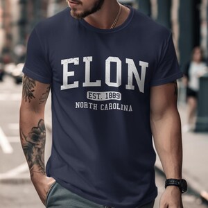 Navy t-shirt with "ELON EST. 1889 NORTH CAROLINA" printed in white text.