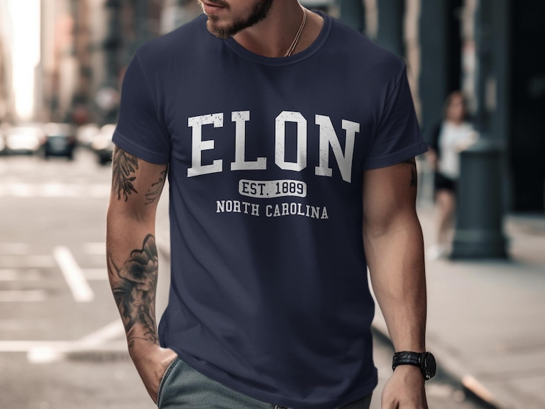 Navy t-shirt with "ELON EST. 1889 NORTH CAROLINA" printed in white text.