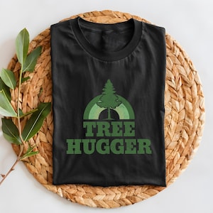 May include: Black t-shirt with a green tree graphic and the text "TREE HUGGER" in green.