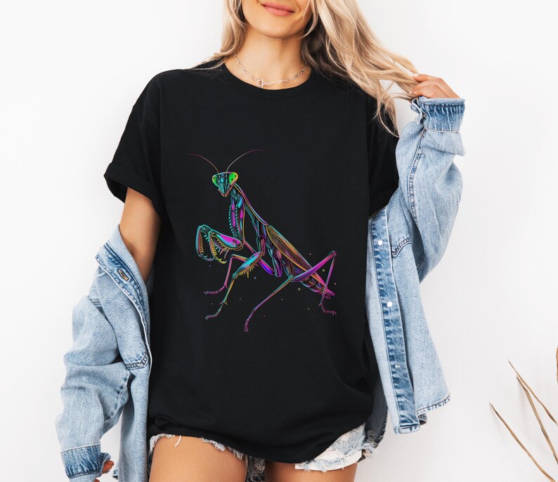 May include: A black t-shirt with a colorful graphic of a praying mantis. The mantis is outlined in neon green, pink, and blue.