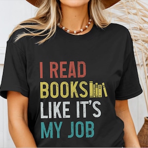 May include: Black t-shirt with a vintage-style graphic that reads "I read books like it's my job".