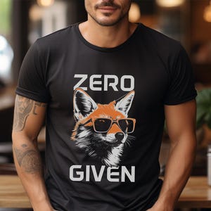 May include: Black t-shirt with a graphic of a fox wearing sunglasses and the text "ZERO GIVEN".