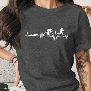 Dark t-shirt with a graphic of a triathlon heartbeat line: swim, bike, run.