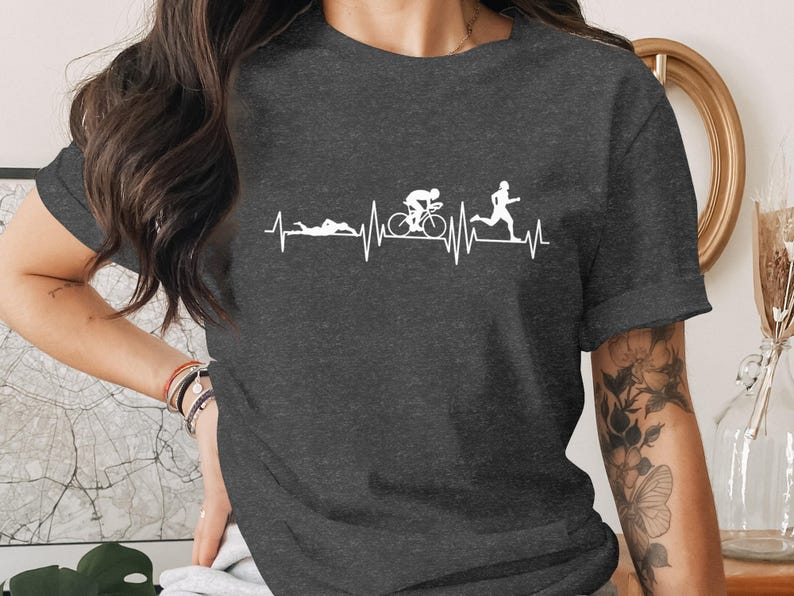 Dark t-shirt with a graphic of a triathlon heartbeat line: swim, bike, run.