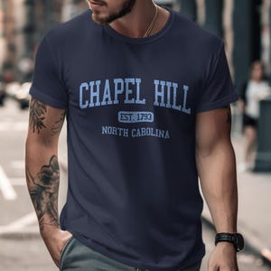 Navy blue t-shirt with "Chapel Hill Est. 1793 North Carolina" in blue.