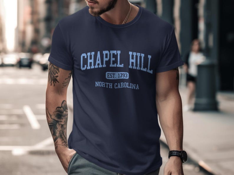 Navy blue t-shirt with "Chapel Hill Est. 1793 North Carolina" in blue.