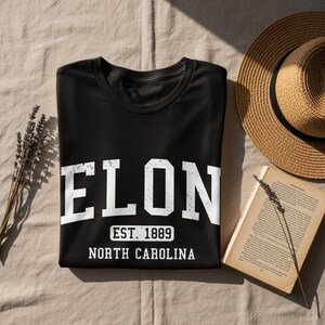 Black t-shirt with "ELON EST. 1889 NORTH CAROLINA" printed in white.