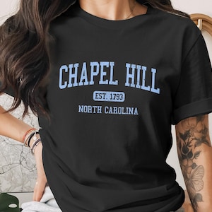 Black t-shirt with light blue "Chapel Hill Est 1793 North Carolina" text.