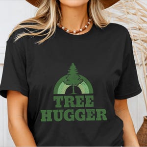 May include: Black t-shirt with a green tree and rainbow graphic and the text "TREE HUGGER" in green.