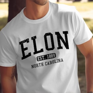 White t-shirt with black text "ELON EST. 1889 NORTH CAROLINA".