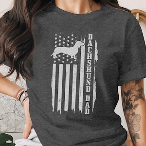 Dark t-shirt with distressed American flag and "DACHSHUND DAD" text.