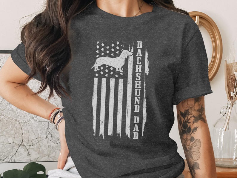 Dark t-shirt with distressed American flag and "DACHSHUND DAD" text.