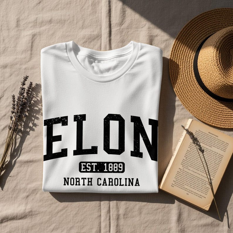 White t-shirt with "ELON EST. 1889 NORTH CAROLINA" text.