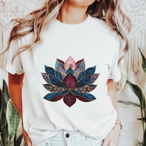 May include: White t-shirt with a colorful lotus flower graphic. The flower is made up of blue, purple, pink, and gold tones.