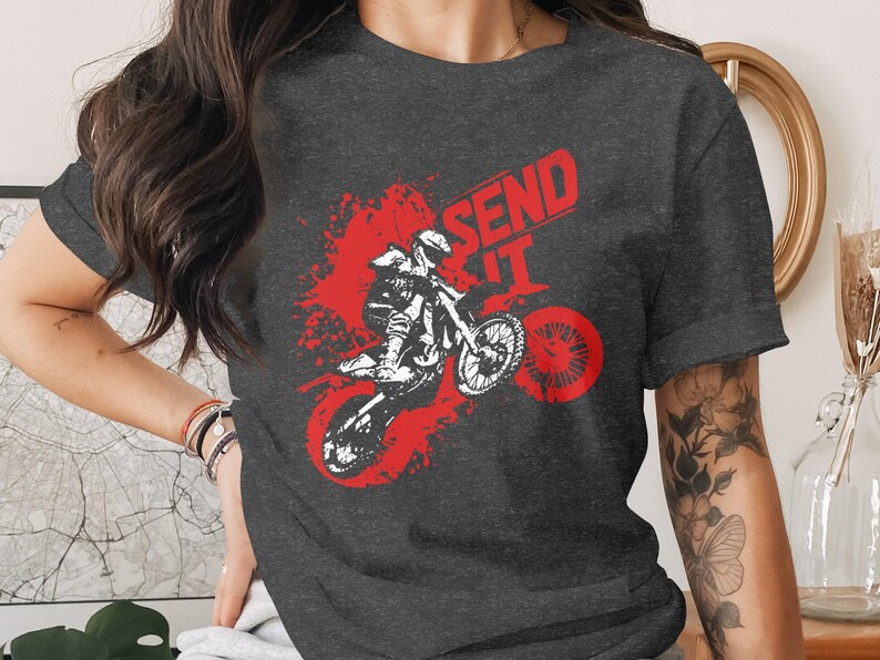 Dark t-shirt with red graphic of motocross rider mid-air, "SEND IT" text.
