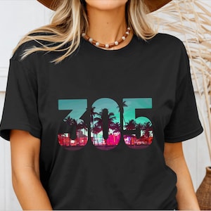 May include: Black t-shirt with a graphic of palm trees and the number 305.