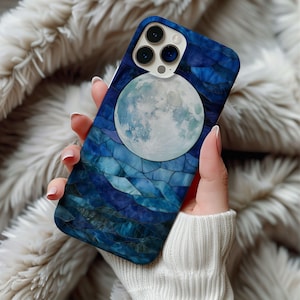 May include: A blue and white phone case with a mosaic design and a full moon image. The case has a camera lens cutout.