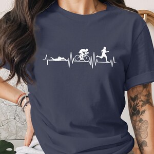 Navy t-shirt with white graphic of a heartbeat line with running and cycling figures.