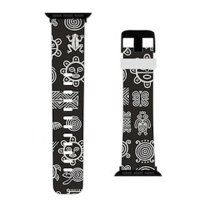 May include: Black and white Apple Watch strap with a repeating pattern of stylized suns, turtles, frogs, and geometric shapes. The strap has a black base with white designs, and a black buckle.