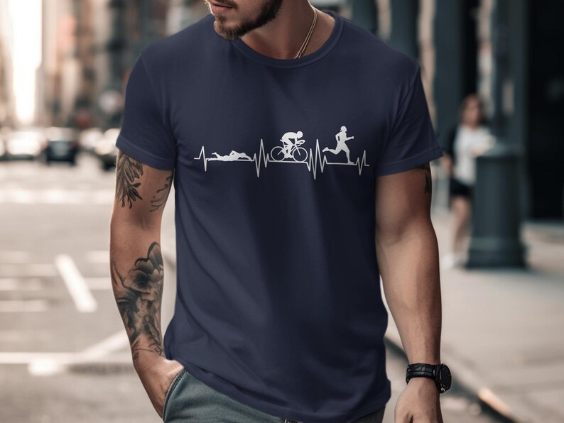 Dark blue t-shirt with a white graphic depicting triathlon activities on a heart rhythm line.