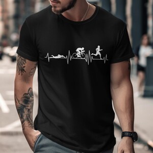 Black t-shirt with white triathlon icons on a heartbeat line.