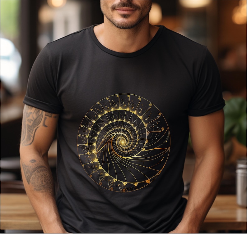 May include: Black t-shirt featuring a gold spiral design. The spiral is a detailed, symmetrical pattern with a central point and radiating lines. The design is centered on the shirt, creating a striking visual.
