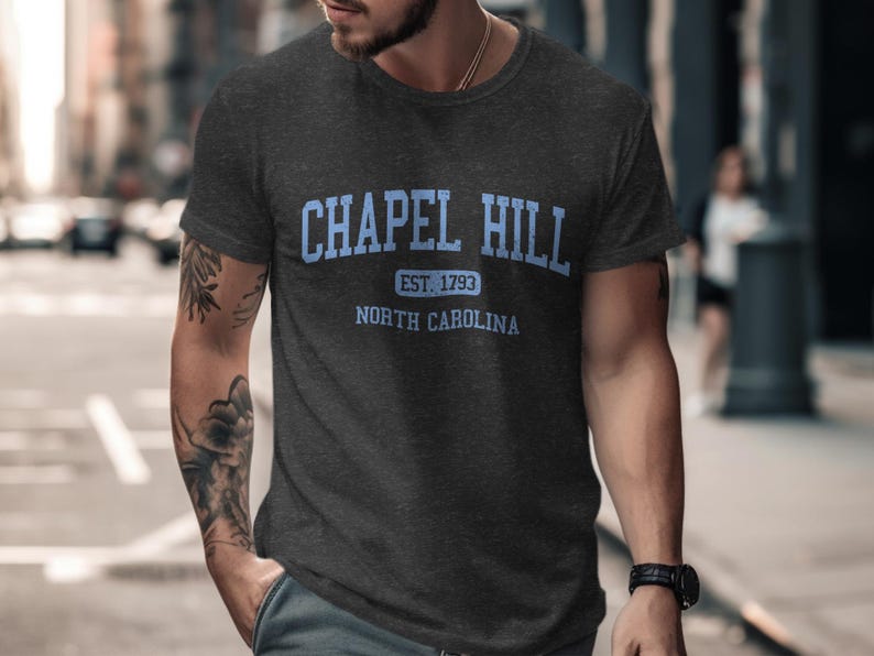 Dark grey t-shirt with "Chapel Hill Est. 1793 North Carolina" in blue text.