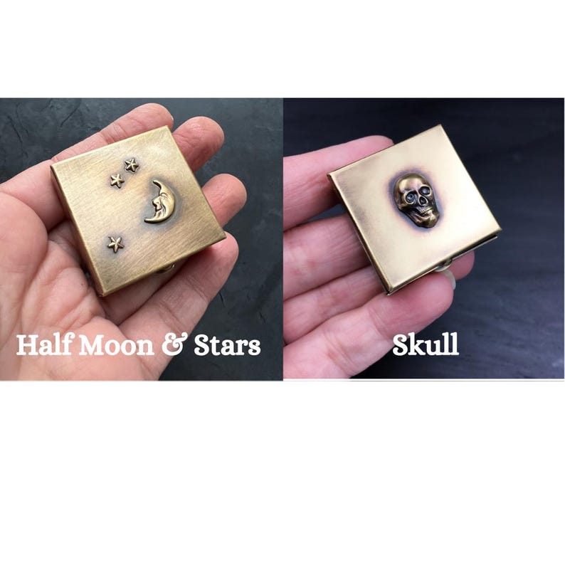 May include: Two small brass boxes with different designs. One box has a half moon and stars design, the other has a skull design.