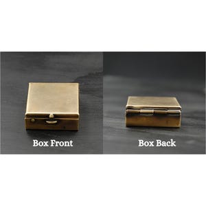 May include: A brass box with a hinged lid. The box is closed in the front view and open in the back view. The box is labeled "Box Front" and "Box Back".