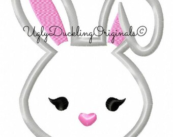May include: Embroidered design of a white bunny with pink ears and a pink heart nose. The bunny has black eyes and eyelashes.