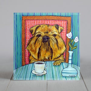 May include: A painting of a Brussels Griffon dog sitting in a colorful chair with a cup of coffee on a table in front of it. The dog is brown and has a white beard. The chair is red, orange, and yellow. The table is blue and green. The background is a blue and green striped wall.