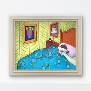 May include: A framed painting depicting a dog sleeping in a bed with a blue floral patterned blanket, a light purple pillow, a wooden nightstand with a lamp and clock, and yellow wallpaper with green leaf patterns, all enclosed in a light frame.
