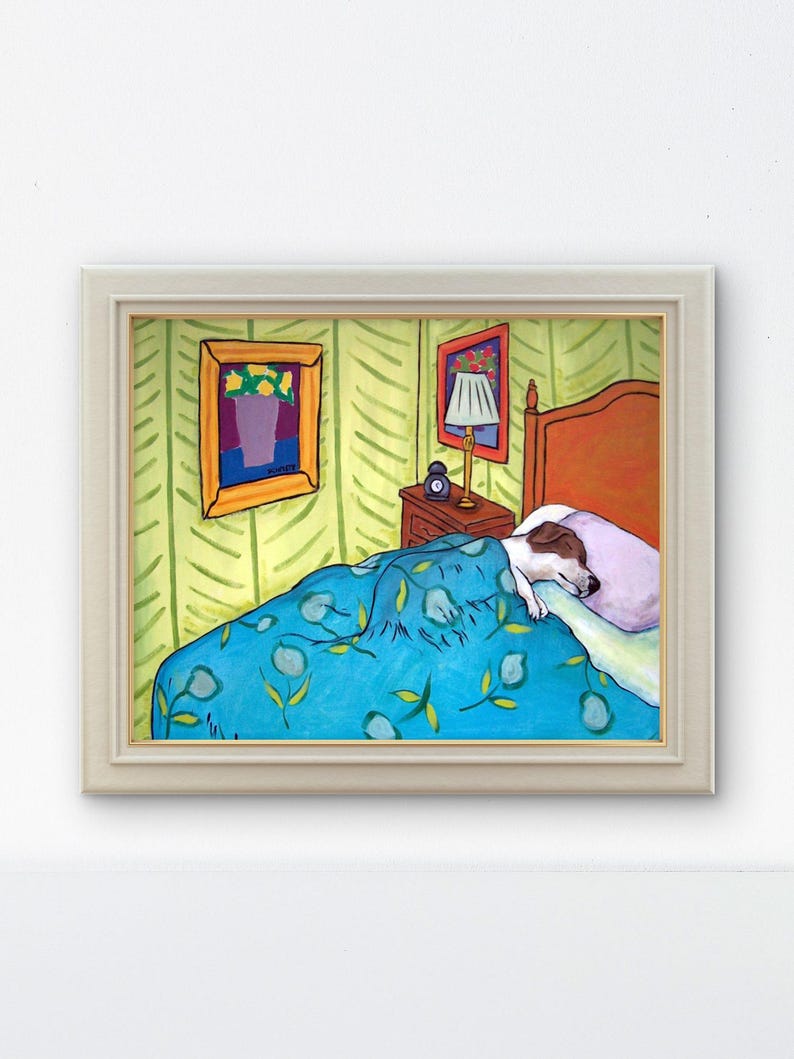 May include: A framed painting depicting a dog sleeping in a bed with a blue floral patterned blanket, a light purple pillow, a wooden nightstand with a lamp and clock, and yellow wallpaper with green leaf patterns, all enclosed in a light frame.