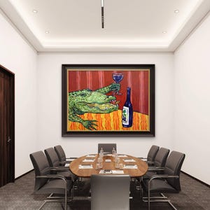 May include: A framed painting hanging on a wall above a conference table. The artwork depicts a green alligator holding a glass of red wine and eating a snack next to a blue wine bottle with a grape label, set against a red and orange background.