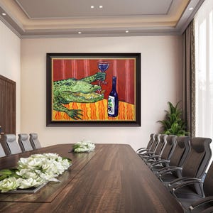 May include: A framed painting hanging on a wall depicts a green alligator sitting at a table with a red striped background. The alligator holds a glass of red wine in one claw and has a blue wine bottle with a grape label sitting on the table.