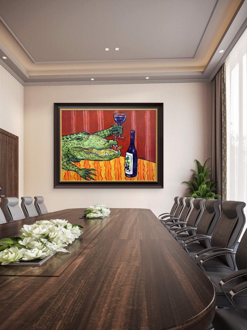 May include: A framed painting hanging on a wall depicts a green alligator sitting at a table with a red striped background. The alligator holds a glass of red wine in one claw and has a blue wine bottle with a grape label sitting on the table.