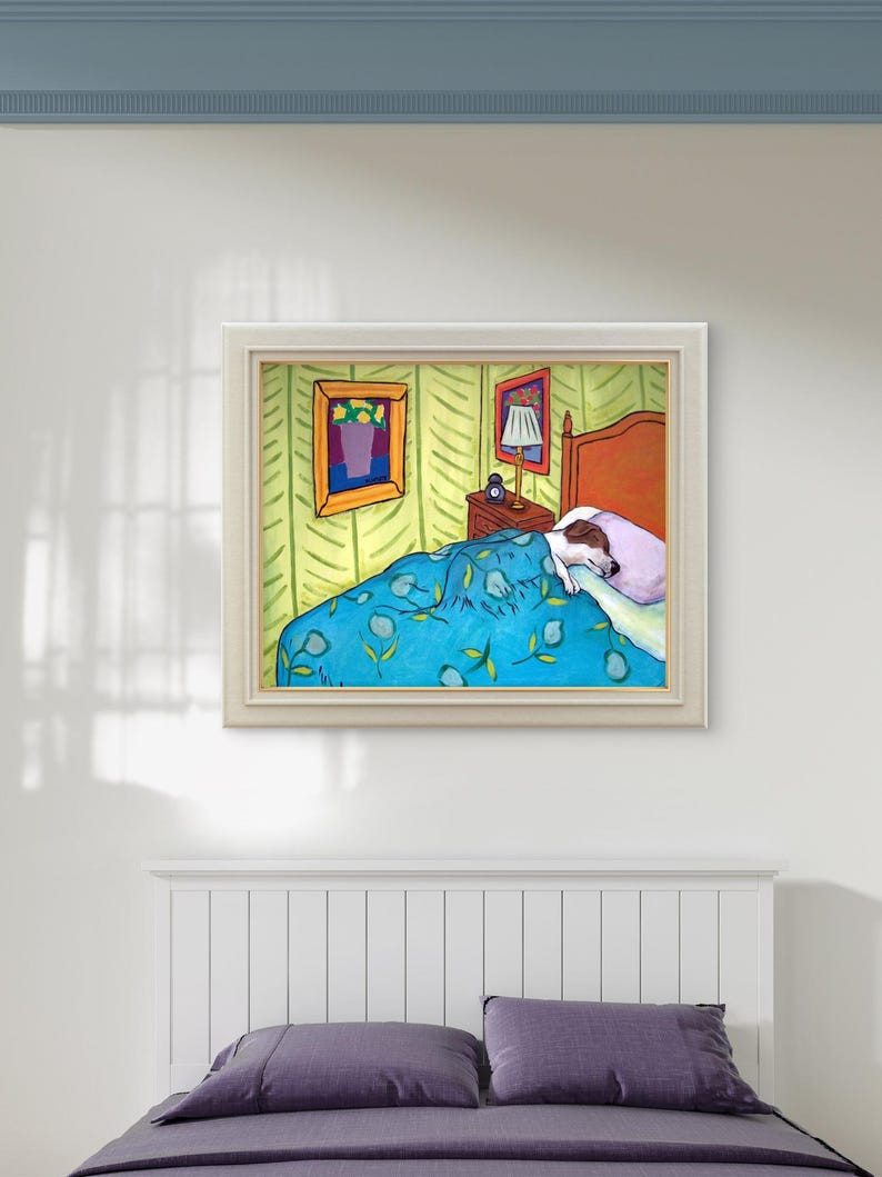 May include: A framed painting depicting a dog sleeping in a bed with a blue patterned quilt and a light purple pillow. The bedroom scene includes a wooden headboard, a nightstand with a lamp, and two framed pictures on the light green walls.