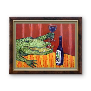 May include: A framed painting featuring a green alligator with an open mouth holding a glass of red wine. Next to the alligator is a dark blue wine bottle with a grape label. The scene is set against a red striped wall and an orange tablecloth.